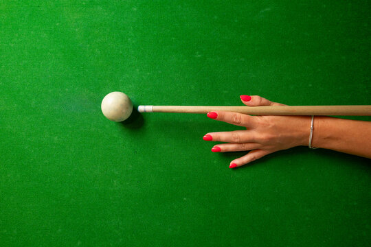 a woman playing billiard top view