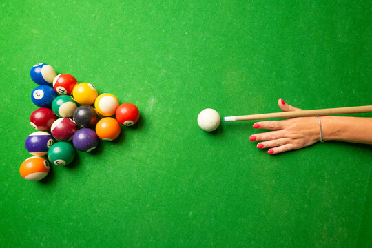a woman playing billiard top view