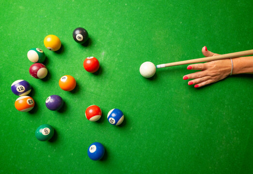 a woman playing billiard top view