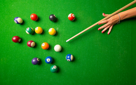 a woman playing billiard top view