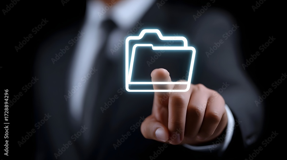 Poster businessman in a suit touching a transparent, glowing file folder icon on a digital interface, repre