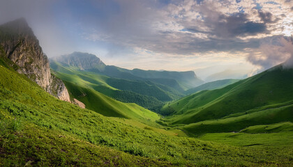 Obraz premium Scenic Mountain Landscape With Lush Green Hills And Misty Valleys Under A Cloudy Sky