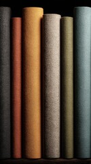 a set of high-quality, fabric book spines in various colors and textures displayed on an isolated black background.