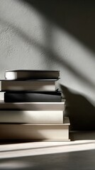  a stack of books, captured in a minimalist setting with soft lighting and shadows.