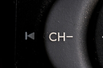 Tv Channel minus icon and button close up of a old black Television remote controller