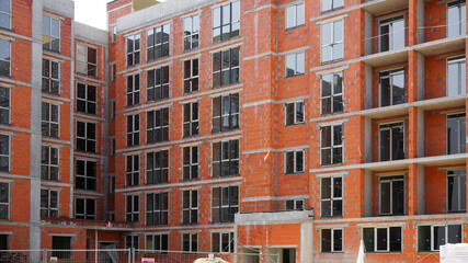 new building with concrete columns and brick walls and windows