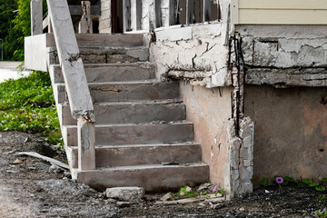 Damaged concrete staircase of old building.