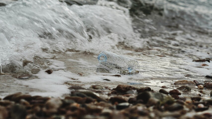 Ocean waves hitting beach with plastic waste