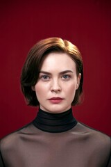Elegant Studio Portrait Of A Woman In Black Turtleneck Against Rich Red Background