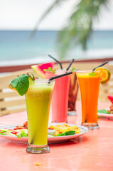 Refreshing Tropical Drinks on a Beach Table A Summer Delight