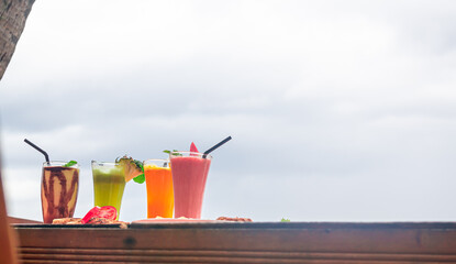 Refreshing Fruit Smoothie Selection Overlooking a Cloudy Sky on the beach