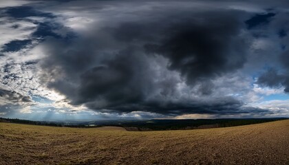 Fototapeta premium dramatic black clouds over an expansive sky in hdr panorama