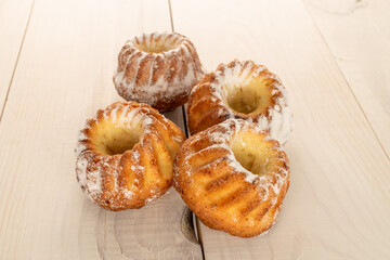 Sweet homemade cupcakes on a wooden table, close-up.