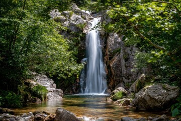 A tranquil waterfall cascades down a rocky cliff face, surrounded by lush greenery and clear water.