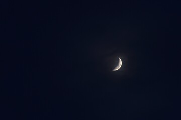 half moon covering by cloud floating on sky in night background