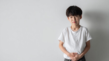 Japanese Child 6 years old holding stomach in discomfort