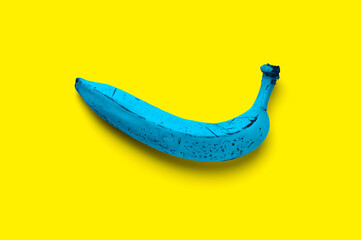 Blue banana on a yellow background - complementary colors