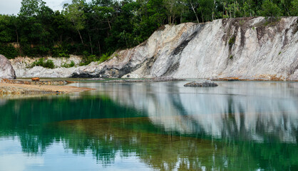 Abandoned quarry pond with green turquoise water.