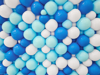 Background of balloons of various sizes in shades of dark blue, light blue, and white. Handmade balloon backdrop arranged tightly in dark blue, light blue, and white for decoration.
