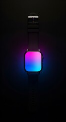 A modern smartwatch with a black strap illuminates the darkness with its vibrant, glowing gradient screen.