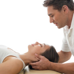 chiropractor adjusts a patient’s back during therapy session