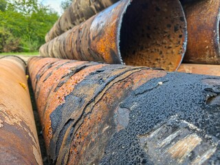 Close-up of corroded pipe surface showing rust, decay, and weathered texture symbolizing aging...