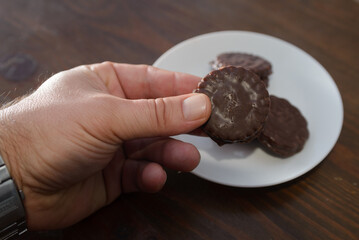 Biscuits covered with chocolate on both sides on a white plate