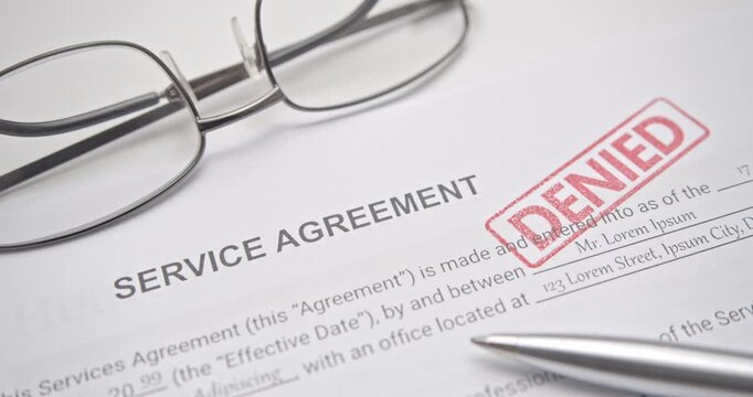 Service Agreement Contract Marked with Red Denied Stamp