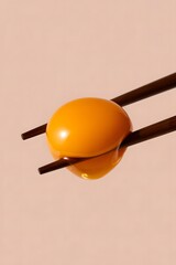 Vibrant Egg Yolk Held by Chopsticks: A Culinary Delight in Minimalist Style