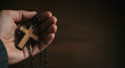 Man holding rosary with cross. All Saints' Day prayer concept. Religious devotion and spiritual worship.