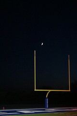 Crescent Moon Over a Goal Post on a Football Field