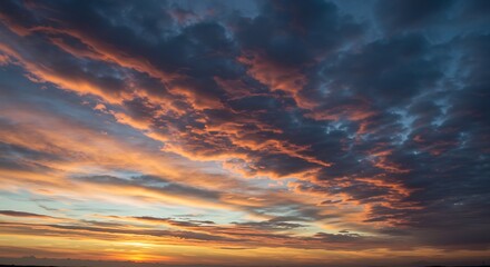 Obraz premium Dramatic sunset sky with colorful clouds and vibrant hues at twilight