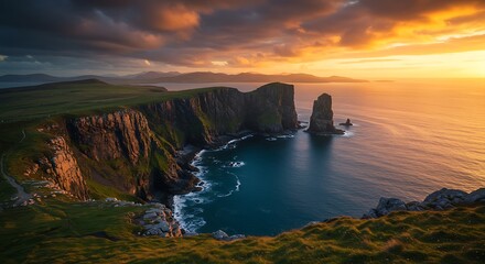 Coastal cliffs under dramatic sunset sky reflecting in calm sea