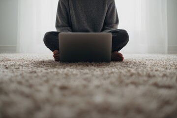 Faceless Person with Laptop &ndash; Cross-Legged on Beige Carpet, Neutral Tones, Minimalist Composition
