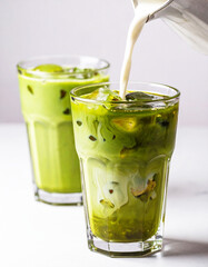 Two glasses of green iced matcha latte. AI