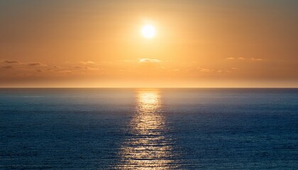 Obraz premium the hazy glow of sunlight on the water s surface creating a mesmerizing effect during the serene sea s morning awakening