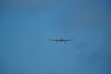 Airplane in the cloudy sky. An airplane flying near an airfield with its landing gear down