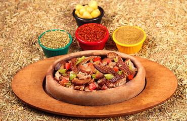 kokorech served mixed with vegetables and spices