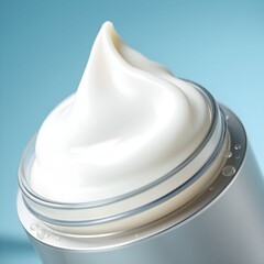Close-up of a jar of white cream on a blue background.