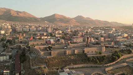 Erzurum, Turkey - 20th august, 2025: Aerial Erzurum Castle and citadel, stone ramparts and clock-tower minaret above city golden hour; Byzantine 5th–6th c.origins with Seljuk - Ottoman restorations