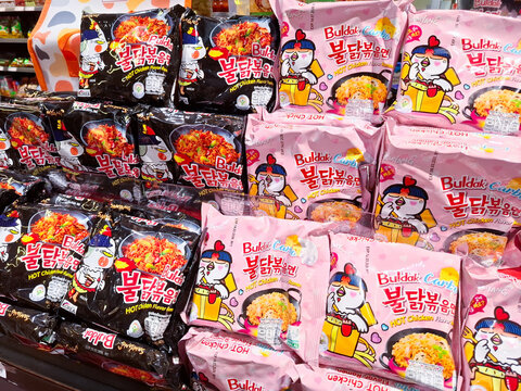 Variety of Samyang Buldak Spicy Chicken Flavor Korean Instant Ramen Noodle Packages Stacked on a Supermarket Shelf Display, on September 19, 2025 in Bangkok, Thailand