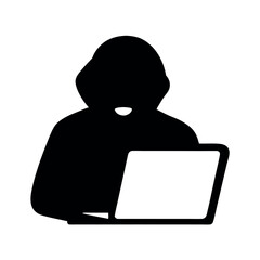 Anonymous hacker silhouette working on a laptop computer in the dark