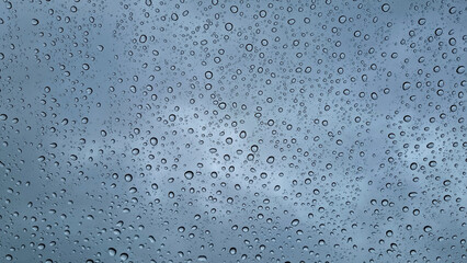 Raindrops on glass close-up. Black and white monochrome. Selective focus