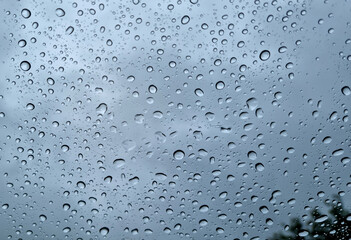 Raindrops on glass close-up. Black and white monochrome. Selective focus