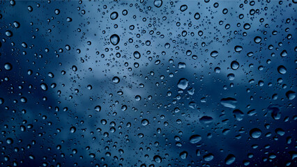 Raindrops on glass close-up. Black and white monochrome. Selective focus
