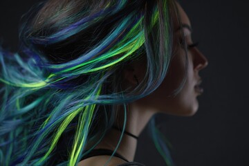 Naklejka premium Vibrant neon blue and green streaked hair