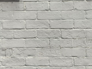 Painted brick wall texture with subtle shadow and rough mortar giving urban neutral backdrop for design and architecture projects