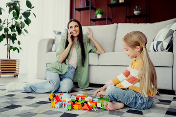 Obraz premium Mother and daughter playing together with colorful toys in living room enjoying shared moments and bonding time