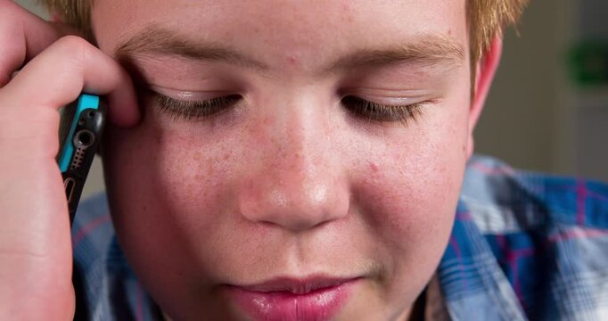 Boy using cell phone close up on face 4k