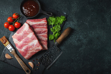 Raw meat. Raw pork ribs from the back with meat on a black background. background image